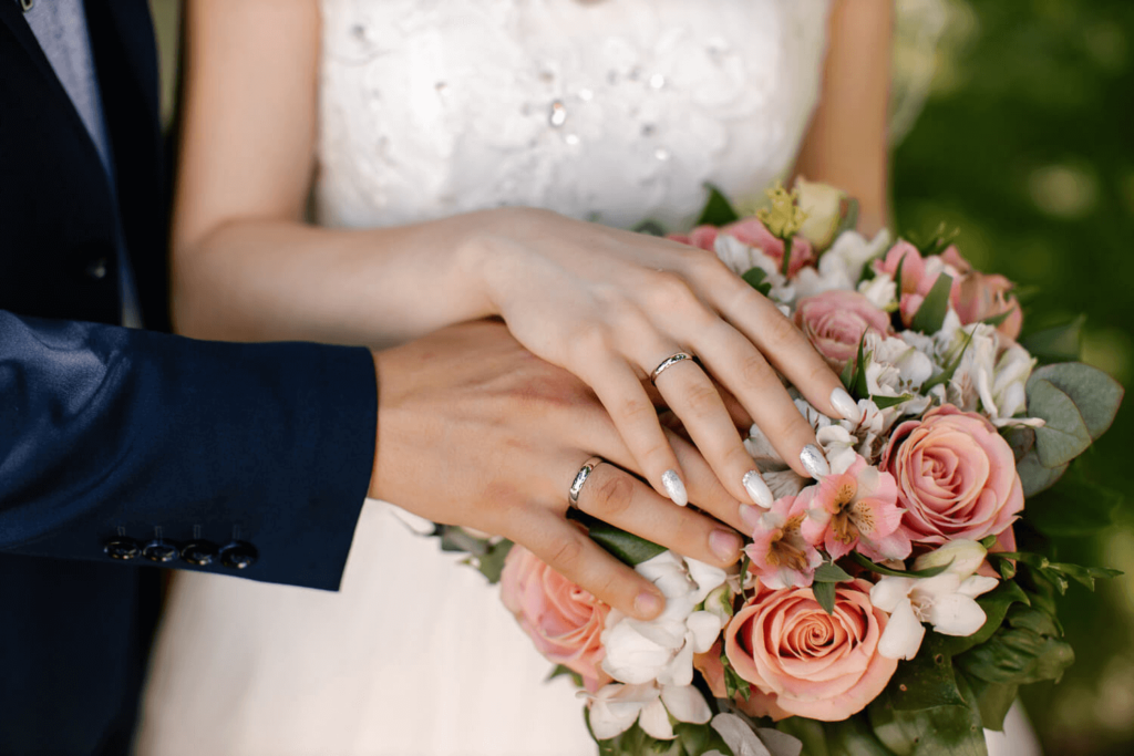 Photo of hands and bouquet during a micro wedding in Lake George