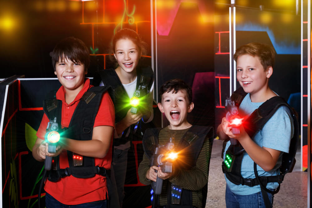 Kids holding laser tag guns, one of the popular indoor activities in Lake George