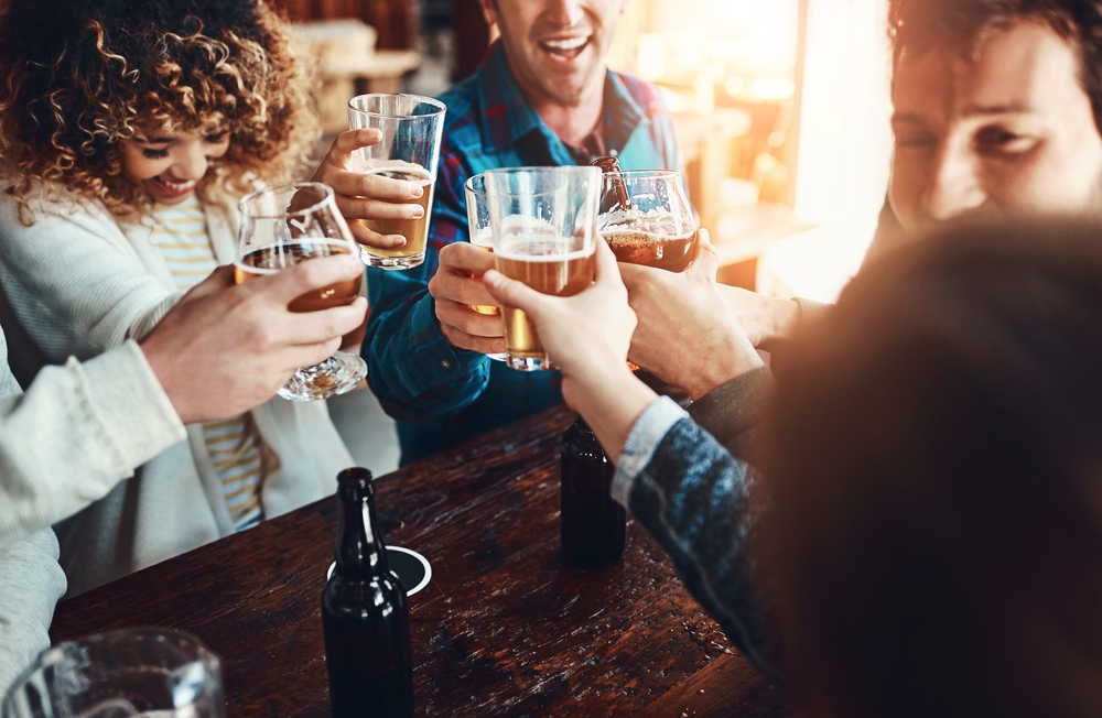 People toasting drinks at Lake George nightlife spots