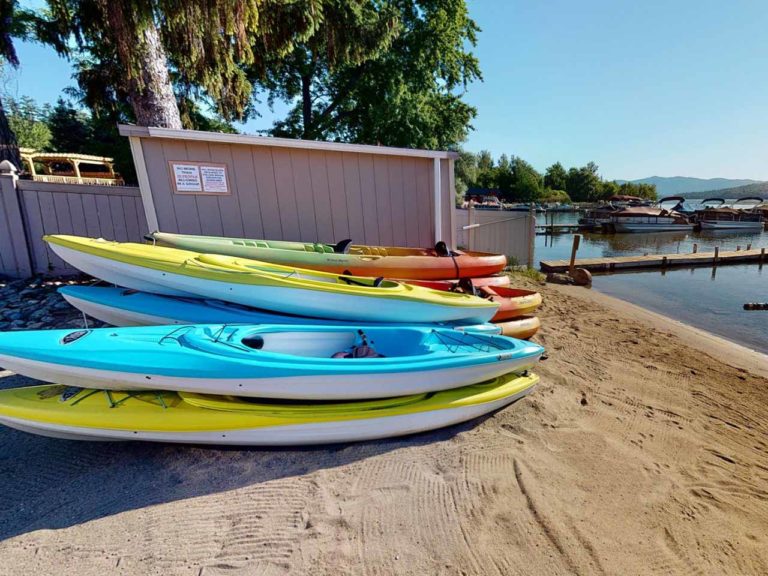 Surfside on the Lake private beach in Lake George with kayaks on the shoreline